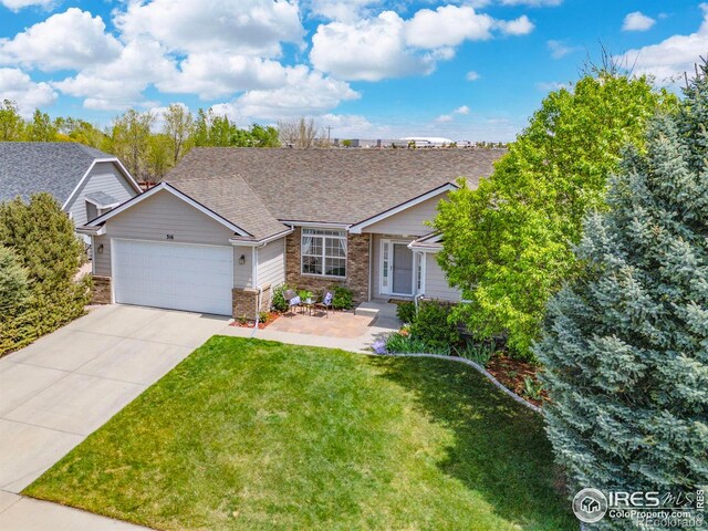 316 Whitney Bay, Windsor, CO 80550 - view of front of property with a garage, driveway, a front yard, brick siding, and roof with shingles