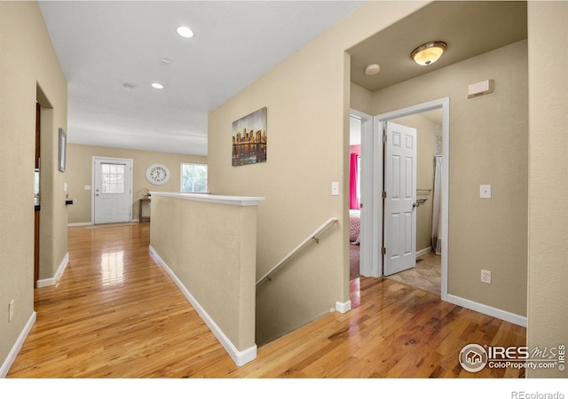316 Whitney Bay, Windsor, CO 80550 - hallway with an upstairs landing, light wood finished floors, baseboards, and recessed lighting