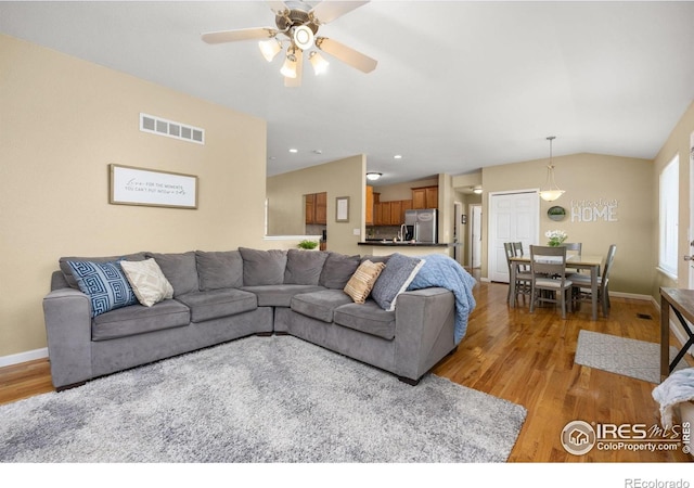 316 Whitney Bay, Windsor, CO 80550 - living room with light wood finished floors, ceiling fan, baseboards, and lofted ceiling