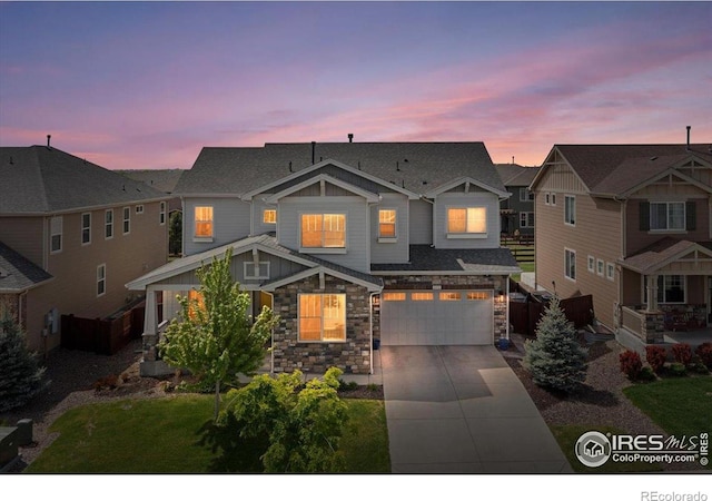 6111 Story Rd, Timnath, CO 80547 - craftsman-style house with stone siding, driveway, an attached garage, and a residential view