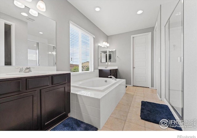 6111 Story Rd, Timnath, CO 80547 - full bath featuring a stall shower, tile patterned flooring, two vanities, a bath, and recessed lighting