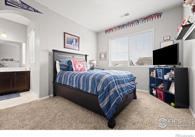 6111 Story Rd, Timnath, CO 80547 - bedroom featuring light colored carpet, arched walkways, and baseboards