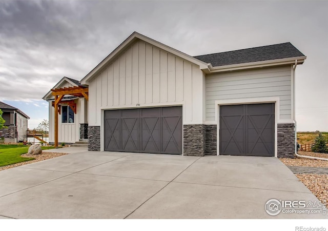 20 Snowcap Dr, Windsor, CO 80550 - view of front of property featuring stone siding and an attached garage