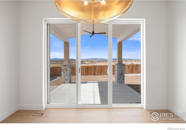 20 Snowcap Dr, Windsor, CO 80550 - entryway with baseboards, a mountain view, wood finished floors, and vaulted ceiling