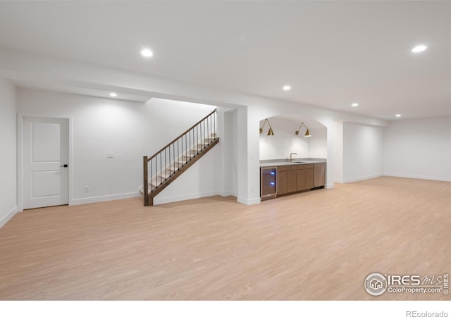 20 Snowcap Dr, Windsor, CO 80550 - basement with light wood-style floors, beverage cooler, stairway, recessed lighting, and baseboards