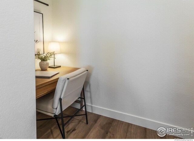 office space with wood finished floors and baseboards