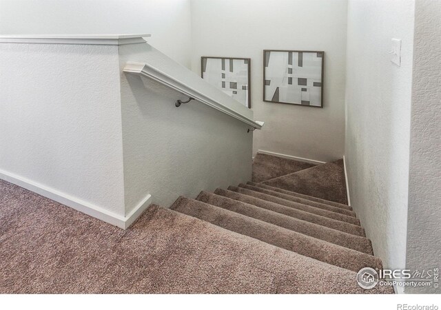 stairway with carpet and baseboards