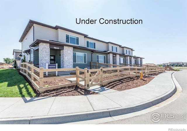 4901 Autumn Leaf Dr, Timnath, CO 80547 - view of front facade featuring a fenced front yard and stone siding