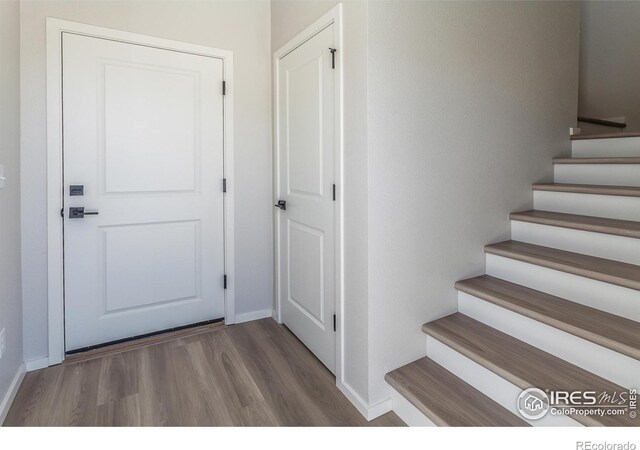 stairs featuring baseboards and wood finished floors