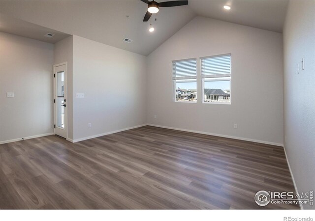 spare room with ceiling fan, wood finished floors, baseboards, vaulted ceiling, and recessed lighting