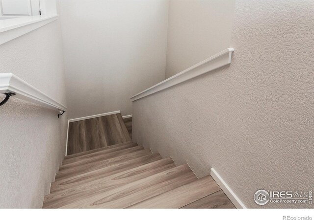 stairs with wood finished floors