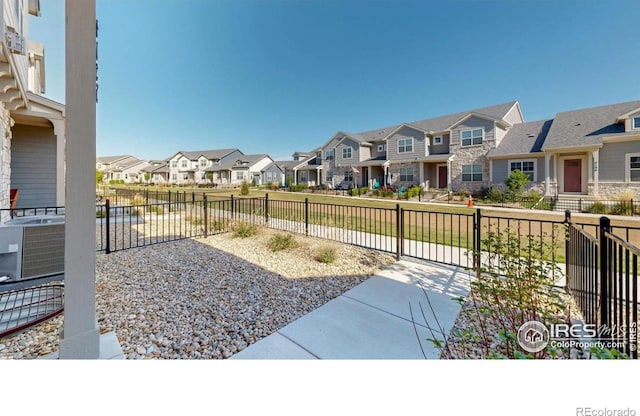 4157 Trapper Lake Dr, Loveland, CO 80538 - view of patio / terrace with a residential view, fence, and central air condition unit