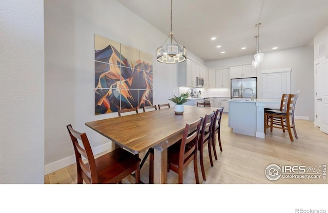 4157 Trapper Lake Dr, Loveland, CO 80538 - dining space with a chandelier, recessed lighting, light wood-style flooring, and baseboards