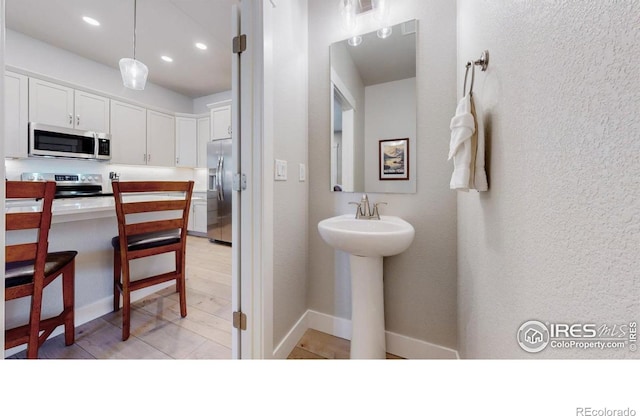 4157 Trapper Lake Dr, Loveland, CO 80538 - bathroom featuring a sink, recessed lighting, and baseboards