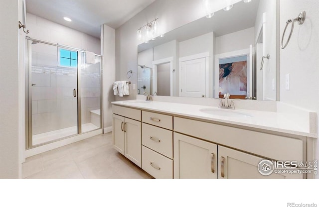 4157 Trapper Lake Dr, Loveland, CO 80538 - bathroom with a shower stall, double vanity, tile patterned floors, and ensuite bathroom