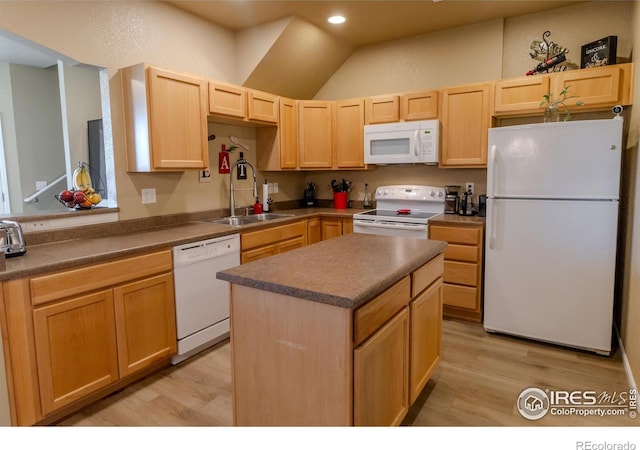 kitchen featuring white appliances, light brown cabinets, a sink, light wood-style flooring, and recessed lighting