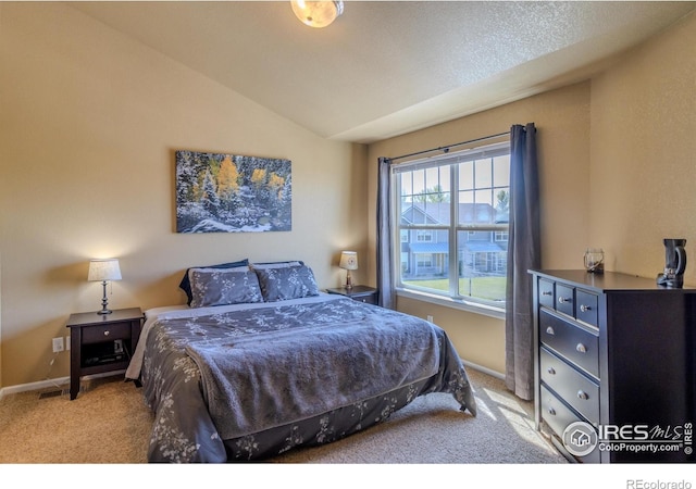 carpeted bedroom featuring vaulted ceiling and baseboards