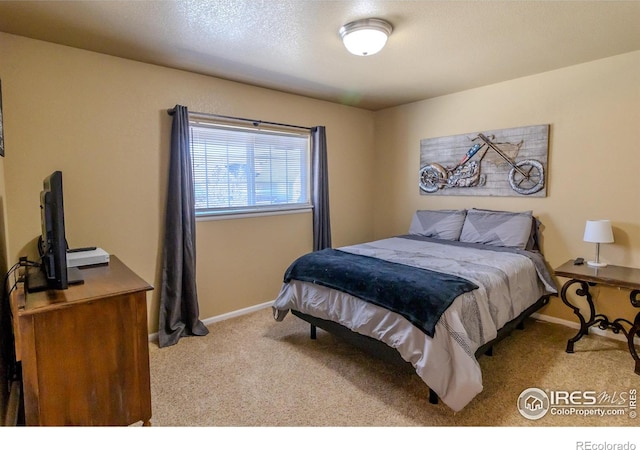 carpeted bedroom featuring baseboards