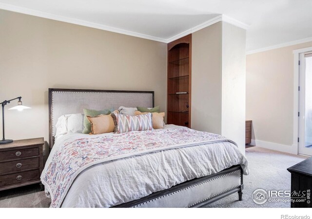 bedroom featuring carpet flooring, crown molding, and baseboards