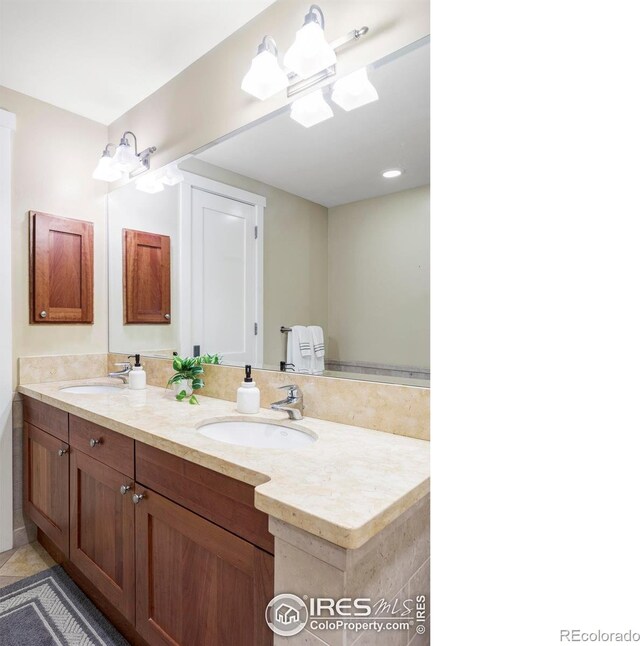 bathroom with double vanity and tile patterned flooring