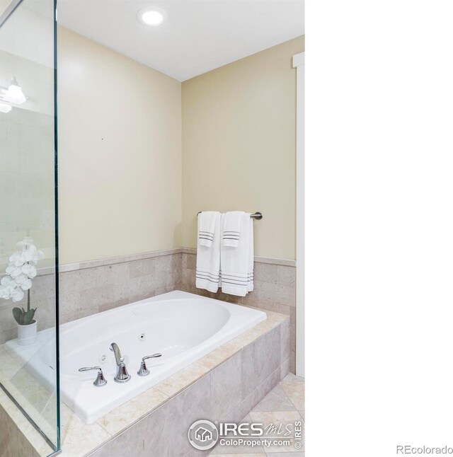 bathroom with a jetted tub, recessed lighting, and tile patterned floors