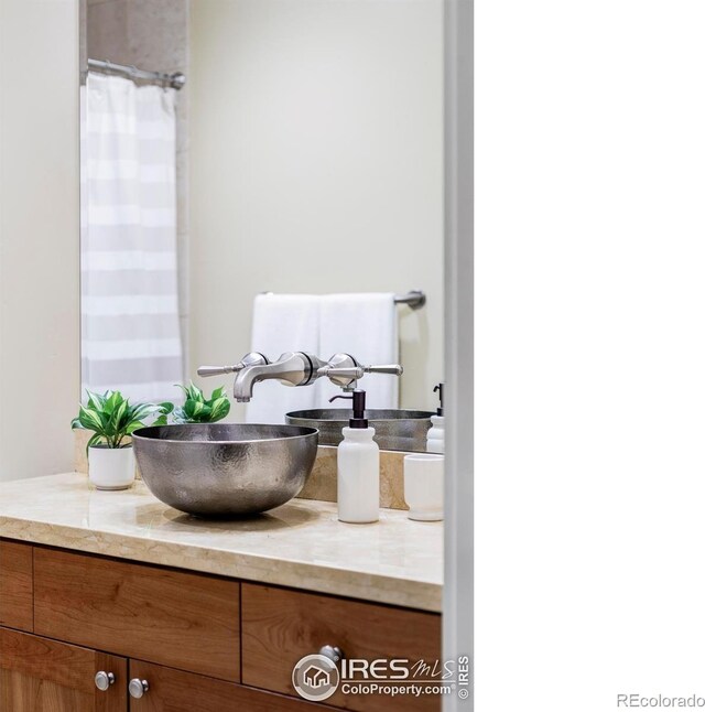 full bath with vanity and a shower with curtain