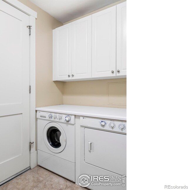 washroom with independent washer and dryer, cabinet space, and light tile patterned floors