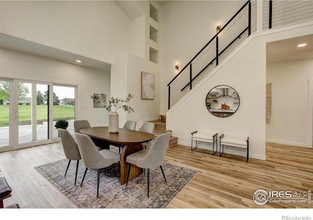 5304 Vardon Way, Fort Collins, CO 80528 - dining area featuring a high ceiling, stairway, light wood-style flooring, and recessed lighting