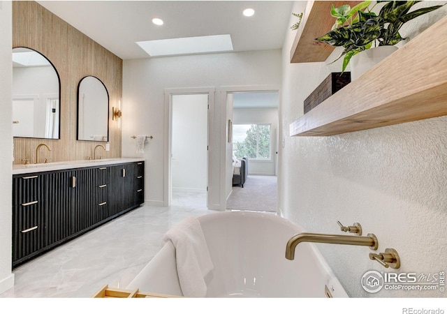 5304 Vardon Way, Fort Collins, CO 80528 - full bath with a skylight, double vanity, a tub to relax in, marble finish flooring, and recessed lighting