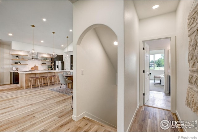5304 Vardon Way, Fort Collins, CO 80528 - corridor featuring recessed lighting, light wood finished floors, and arched walkways