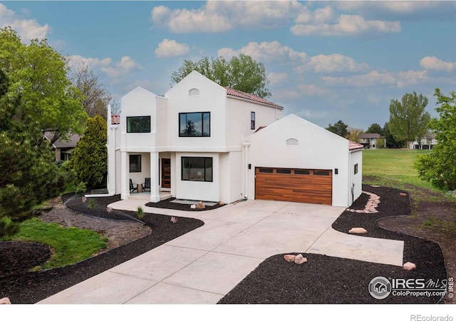 5304 Vardon Way, Fort Collins, CO 80528 - view of front facade with concrete driveway, stucco siding, an attached garage, and a front yard