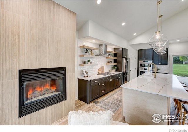 5304 Vardon Way, Fort Collins, CO 80528 - kitchen with extractor fan, open shelves, light stone counters, appliances with stainless steel finishes, and lofted ceiling