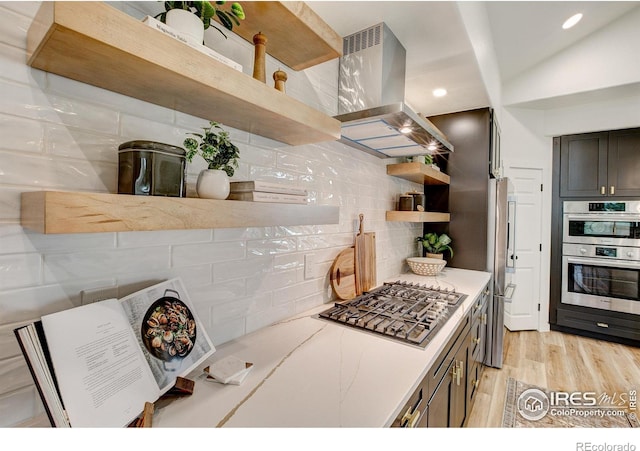 5304 Vardon Way, Fort Collins, CO 80528 - kitchen featuring open shelves, island range hood, stainless steel appliances, backsplash, and light wood-style flooring