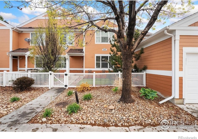 2155 Grays Peak Dr Unit 101, Loveland, CO 80538 - view of front of home with a fenced front yard and a gate