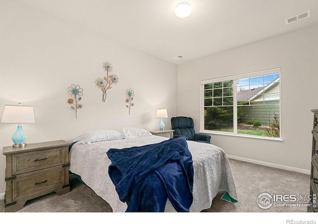 bedroom featuring light colored carpet and baseboards