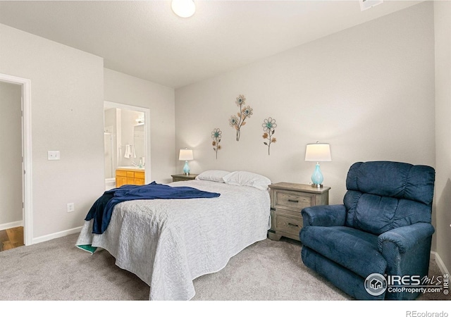 carpeted bedroom featuring baseboards and ensuite bath