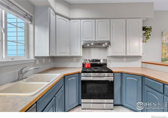 1369 Padfield Pl, Erie, CO 80516 - kitchen featuring stainless steel gas range oven, a sink, under cabinet range hood, blue cabinetry, and white cabinetry