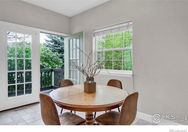 1369 Padfield Pl, Erie, CO 80516 - dining room with healthy amount of natural light, light tile patterned flooring, and baseboards