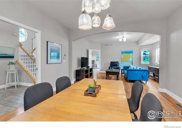 1369 Padfield Pl, Erie, CO 80516 - dining space with arched walkways, stairway, and baseboards