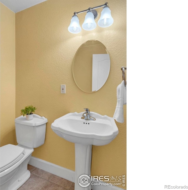 1369 Padfield Pl, Erie, CO 80516 - half bathroom featuring tile patterned flooring, toilet, and baseboards