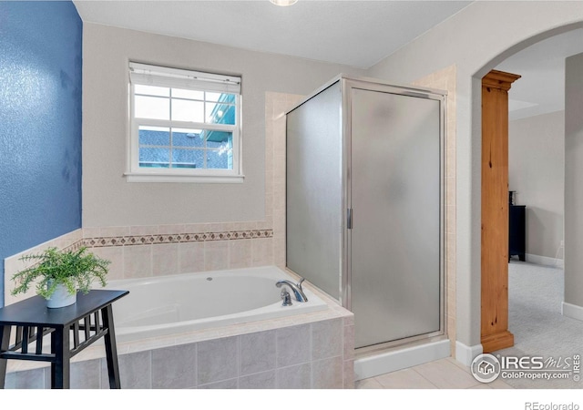 1369 Padfield Pl, Erie, CO 80516 - full bathroom with a bath, a shower stall, and baseboards