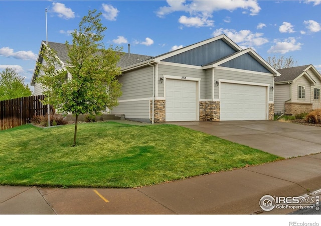 1458 S Dusk Dr, Milliken, CO 80543 - view of front of property featuring an attached garage, concrete driveway, and stone siding