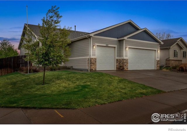 1458 S Dusk Dr, Milliken, CO 80543 - view of front of property with a garage, driveway, and stone siding
