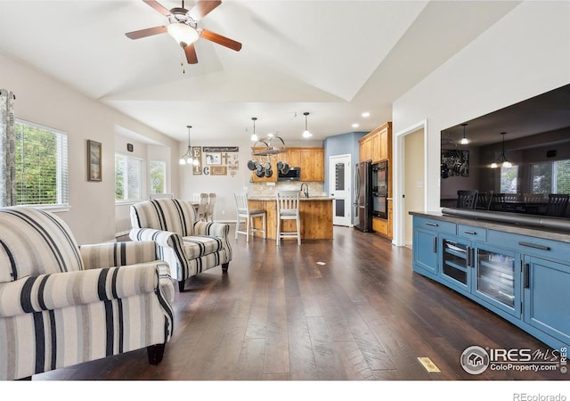 1458 S Dusk Dr, Milliken, CO 80543 - living area featuring a chandelier, vaulted ceiling, dark wood-style flooring, ceiling fan, and recessed lighting