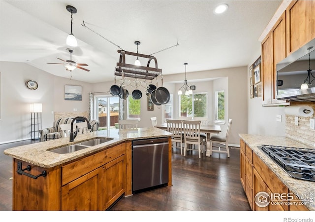 1458 S Dusk Dr, Milliken, CO 80543 - kitchen with appliances with stainless steel finishes, a sink, a ceiling fan, decorative light fixtures, and vaulted ceiling
