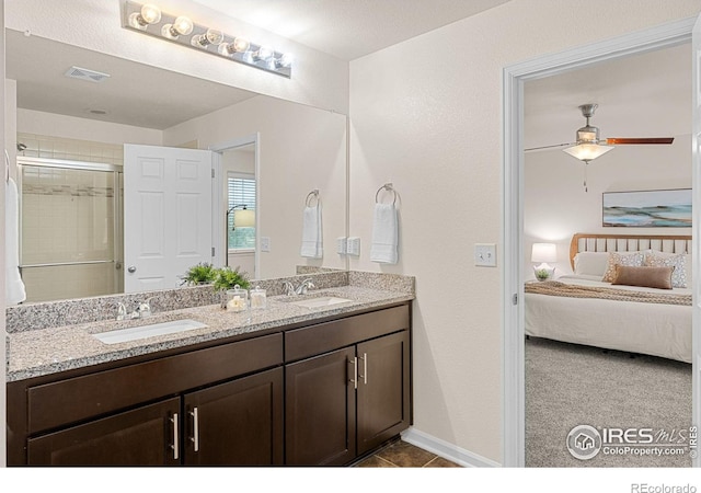 687 Jarvis Dr, Erie, CO 80516 - ensuite bathroom with double vanity, ceiling fan, a shower, tile patterned floors, and baseboards
