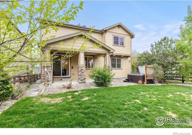 687 Jarvis Dr, Erie, CO 80516 - view of front of property featuring a hot tub, a front yard, central AC, and a porch