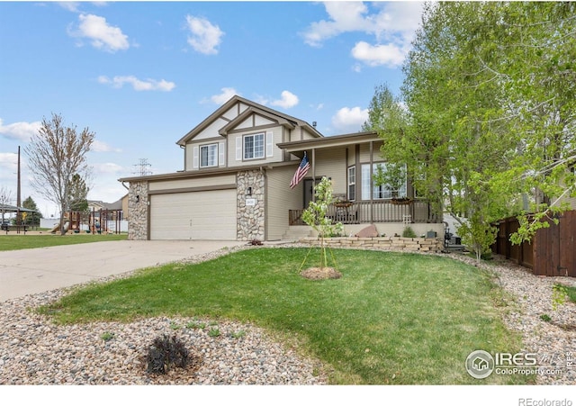 tri-level home with concrete driveway, stone siding, a porch, and a garage