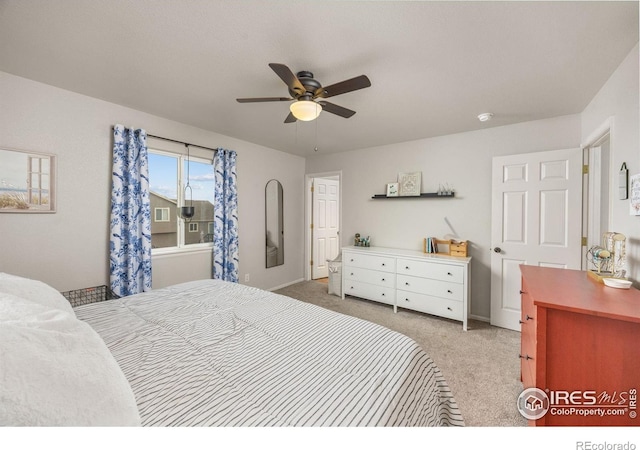 bedroom with light colored carpet, a ceiling fan, and baseboards
