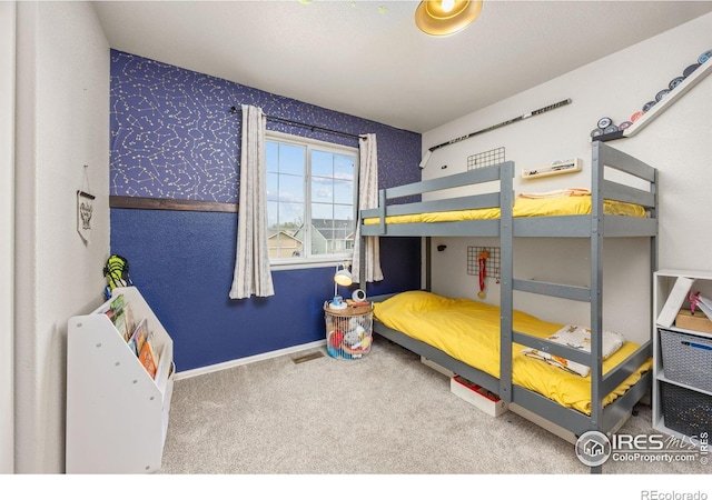 bedroom with carpet floors, baseboards, and wallpapered walls